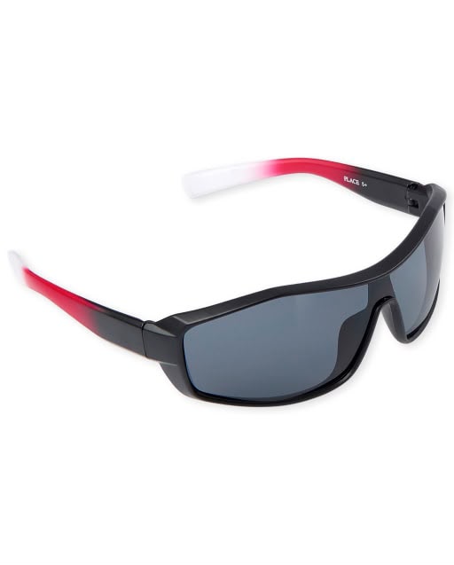 Lentes de sol deportivos infantiles negros con detalles rojos y protección UV disponibles en Rosy Badia.