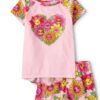 Pijama infantil de algodón para niña con flores sonrientes y short estampado floral.
