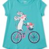 camiseta turquesa de perrita en bicicleta para niña
